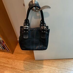 Tignanello black pebbles leather handbag with big buckles.